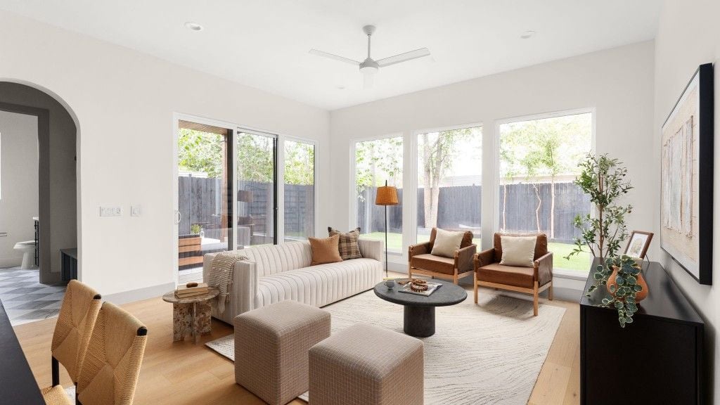 Primary bedroom with vaulted ceiling and large window to the trees